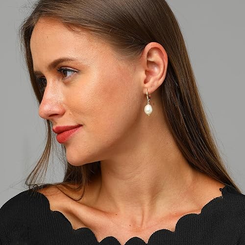 Small Hoop Gold Earrings with Crystal Drop Charm worn by a model, showcasing elegance and style.