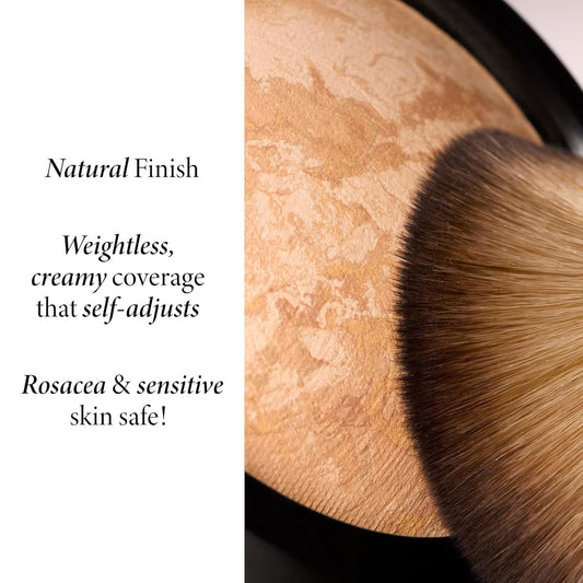 Cosmetic product with a brush on a textured surface, labeled for natural finish and skin safety.